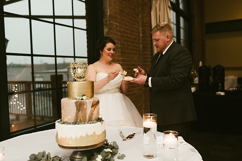 couple eating cake at bergstaff place fall wedding