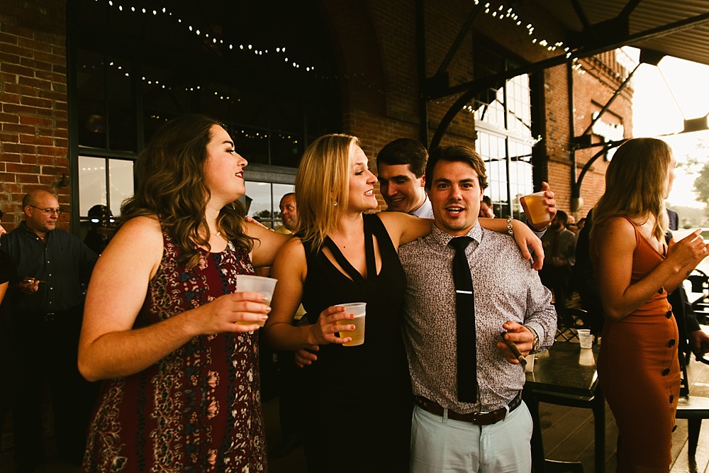 wedding guests smiling and drinking at bergstaff place fall wedding