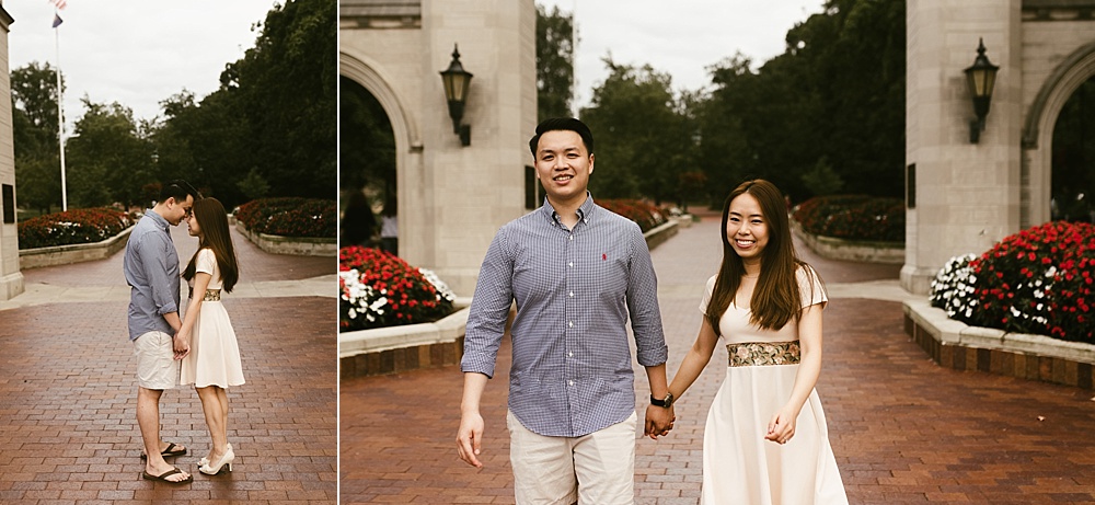 couple kissing and holding hands in front of sample gates at indiana university bloomington engagement session