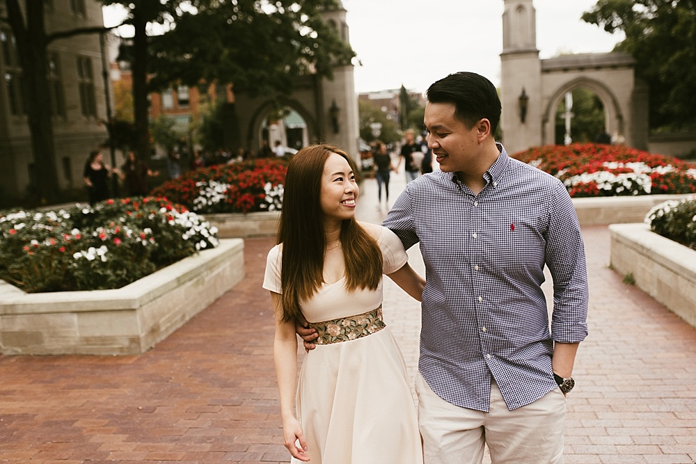 couple hugging in front of sample gates at indiana university bloomington engagement session