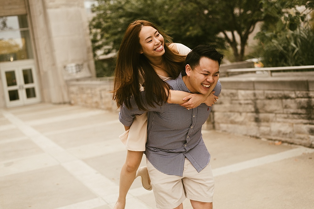 couple laughing in front of library at indiana university bloomington engagement session