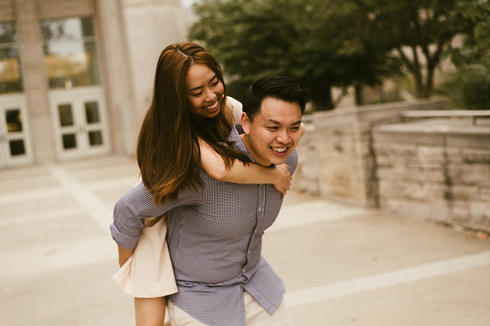 couple hugging in front of library at indiana university bloomington engagement session