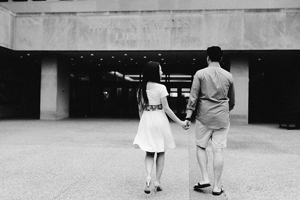 couple holding hands outside library at indiana university bloomington engagement session