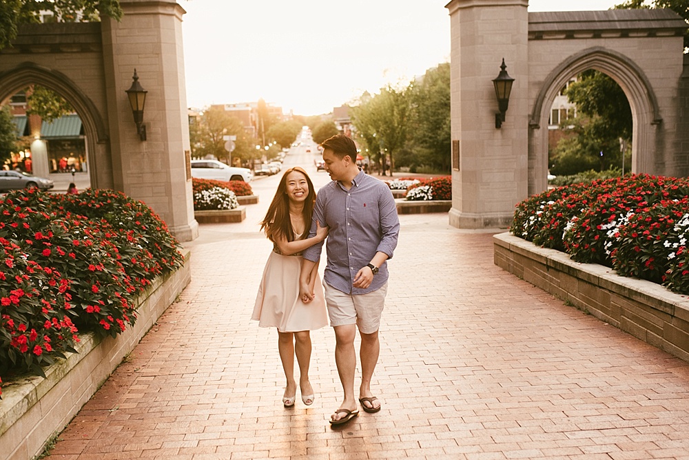 couple holding hands in front of sample gates at indiana university bloomington engagement session