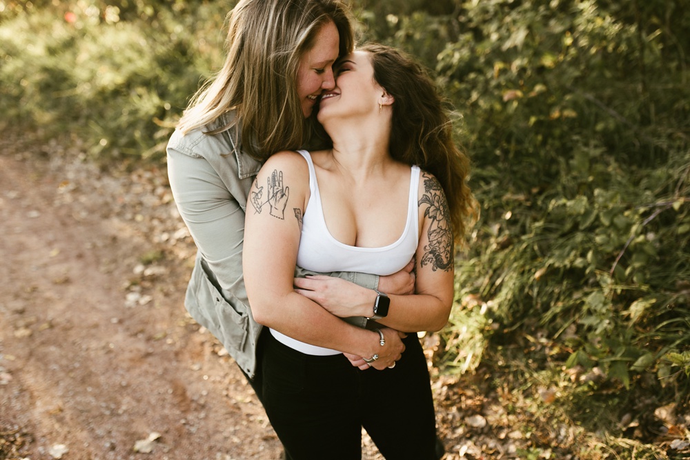 couple hugging at coffee creek watershed preserve engagement session