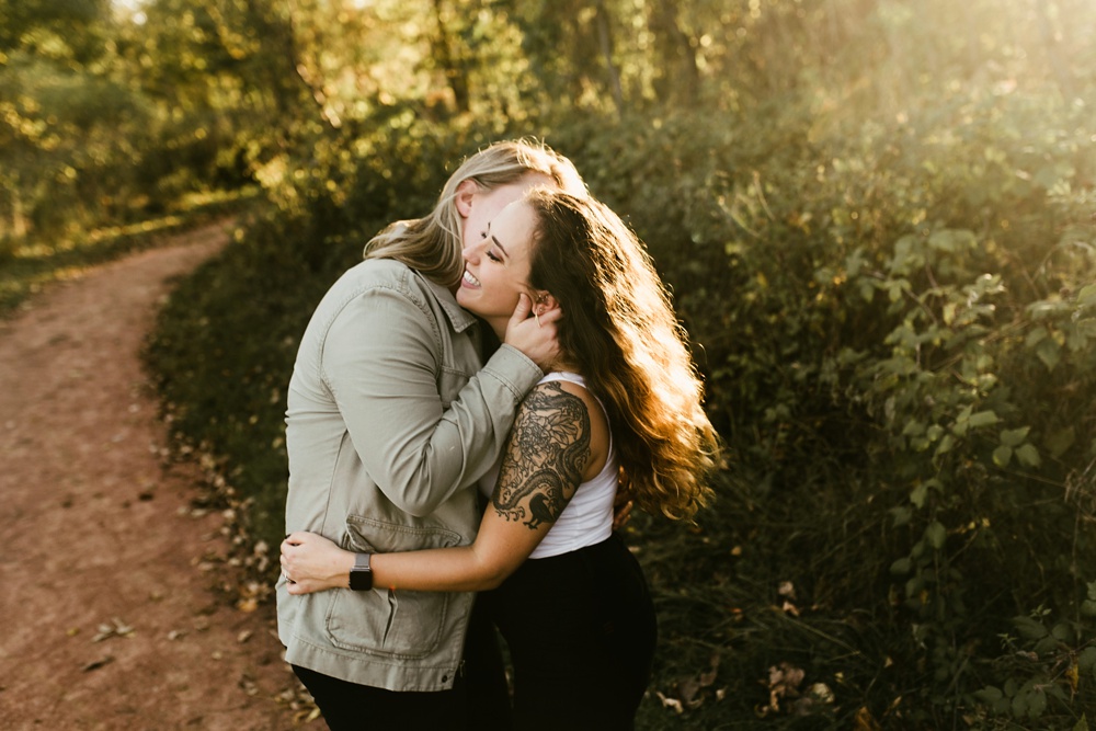 couple kissing at coffee creek watershed preserve engagement session