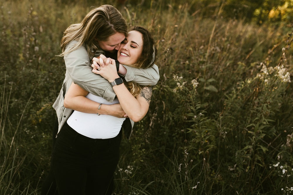 couple hugging at coffee creek watershed preserve engagement session