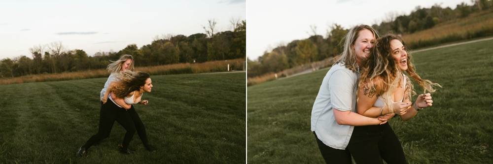 couple wrestling in field at coffee creek watershed preserve engagement session