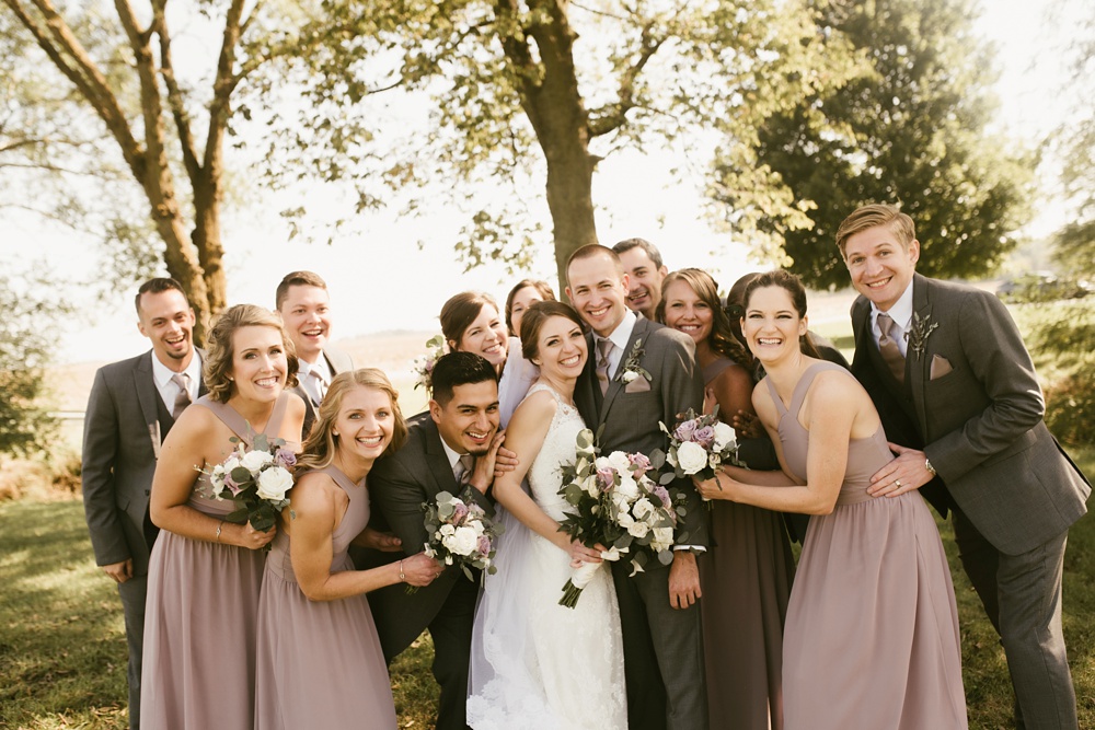 wedding party smiling with bride and groom at indiana wesleyan fairmount campground wedding