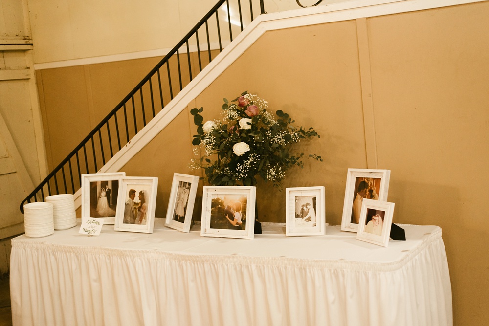 table of pictures at indiana wesleyan fairmount campground wedding