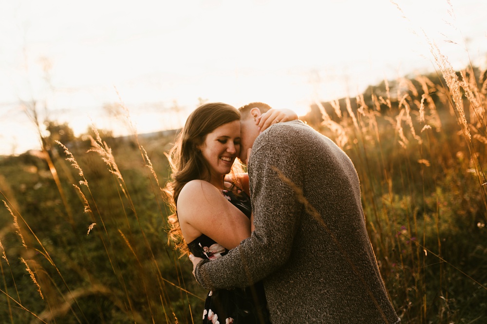 couple kissing in field at golden hour fort wayne autumn engagement session