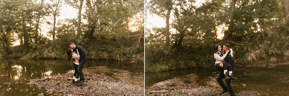 couple kissing in forest at auburn sunrise engagement session