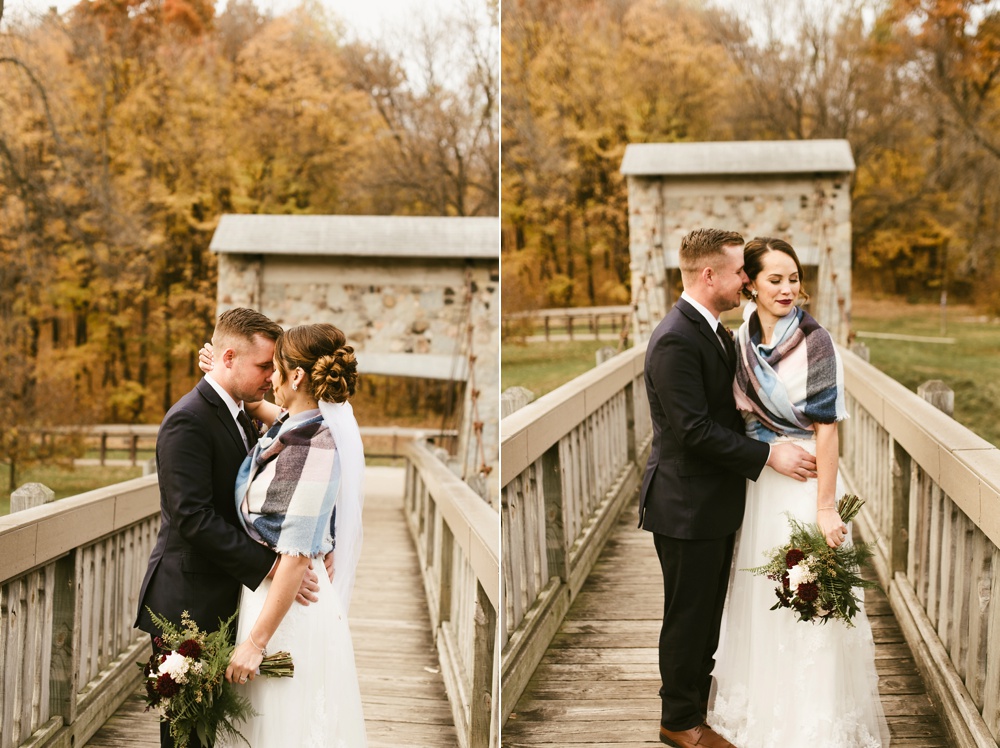 bride and groom hugging on bridge with scarf at green bay pamperin park rock garden wedding