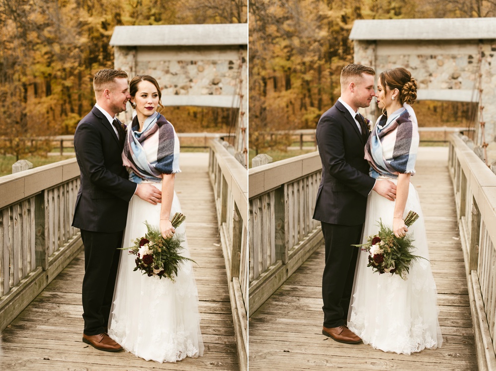 bride and groom hugging on bridge at green bay pamperin park rock garden wedding