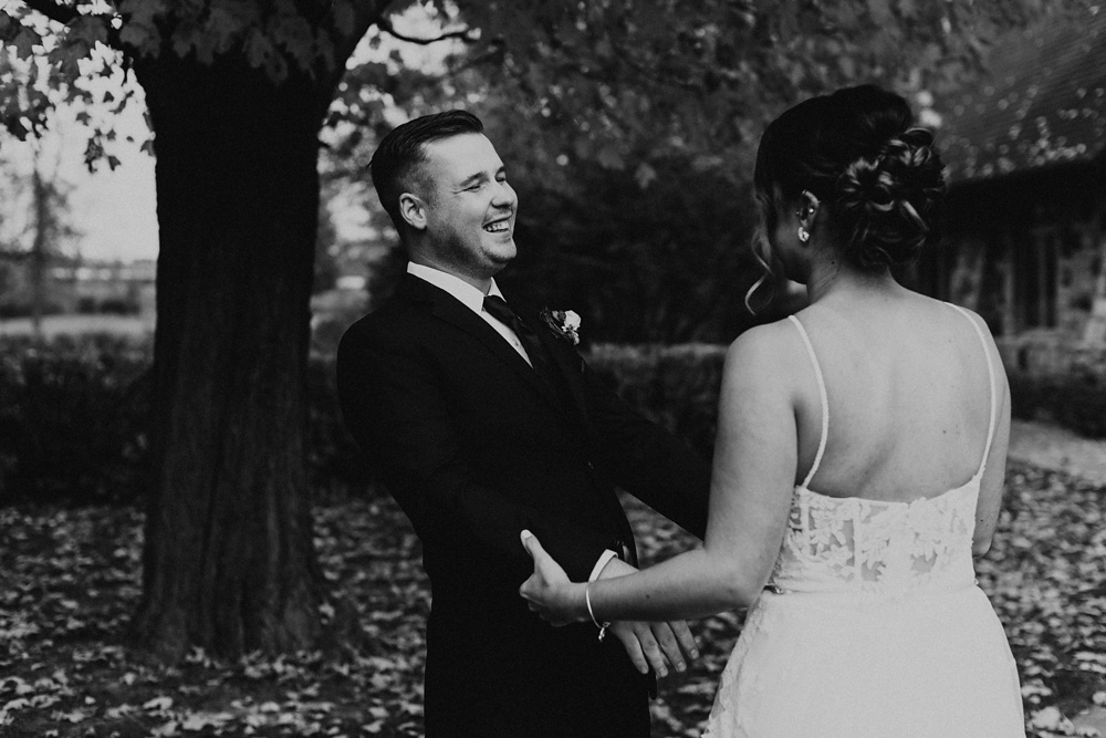 bride and groom smiling at each other at green bay pamperin park rock garden wedding
