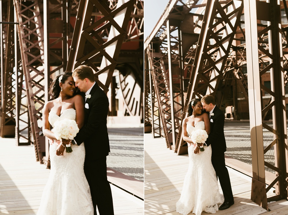 bride and groom kissing on bridge at chicago wedding