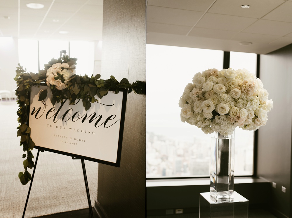 white rose centerpiece and welcome sign at skydeck willis tower wedding