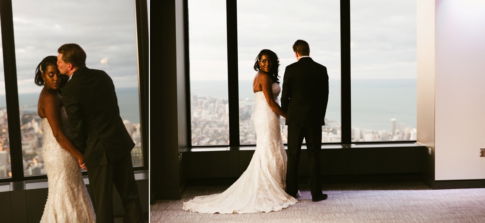 bride and groom holding hands in front of window at skydeck willis tower wedding