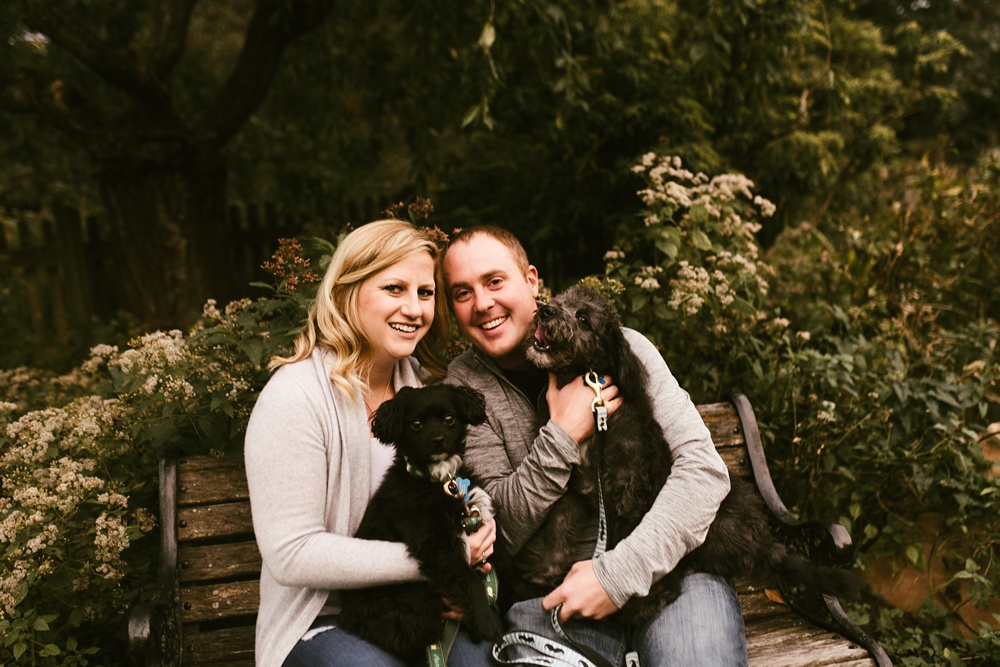 couple holding puppies at downtown fort wayne engagement session