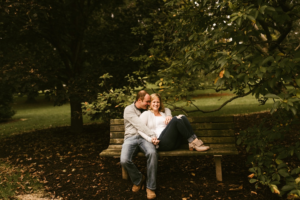 couple hugging in grass at downtown fort wayne engagement session
