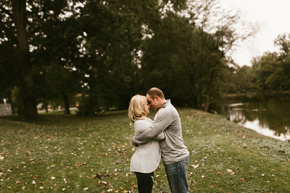 couple hugging in field at downtown fort wayne engagement session