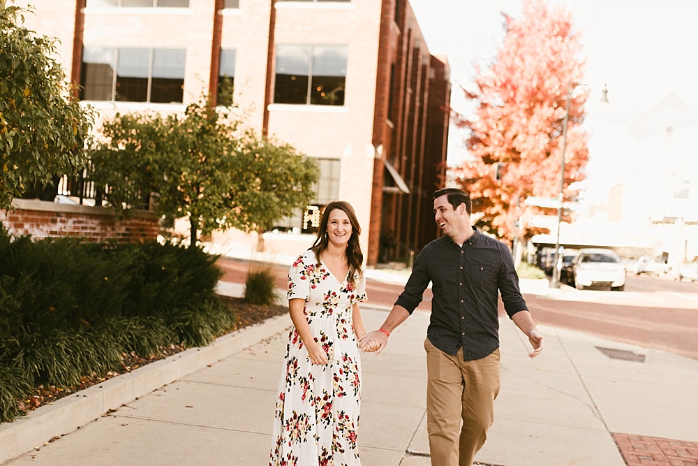 couple holding hands at downtown grand rapids engagement session