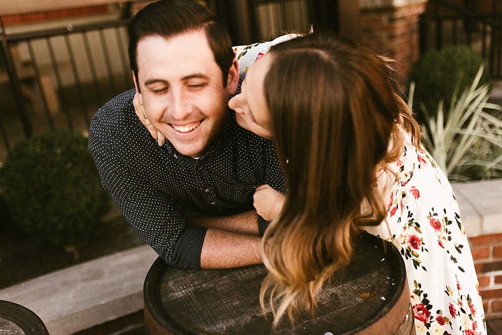 couple kissing at downtown grand rapids engagement session
