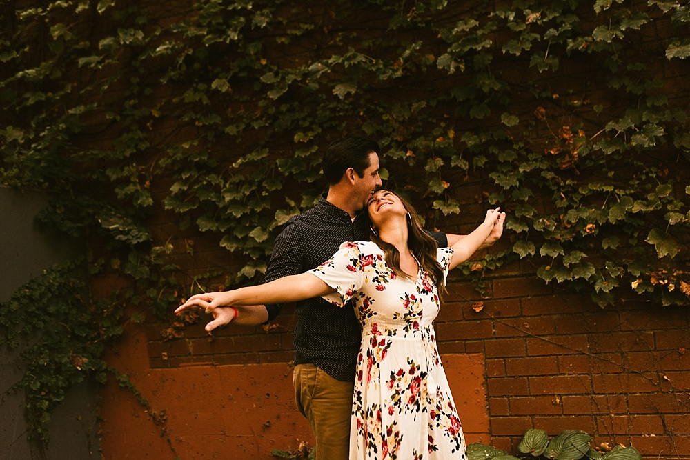 couple doing titanic pose at downtown grand rapids engagement session