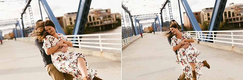 couple laughing on bridge at downtown grand rapids engagement session