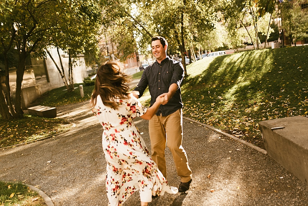 couple spinning at downtown grand rapids engagement session