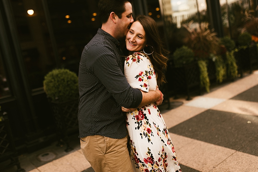 couple hugging at downtown grand rapids engagement session