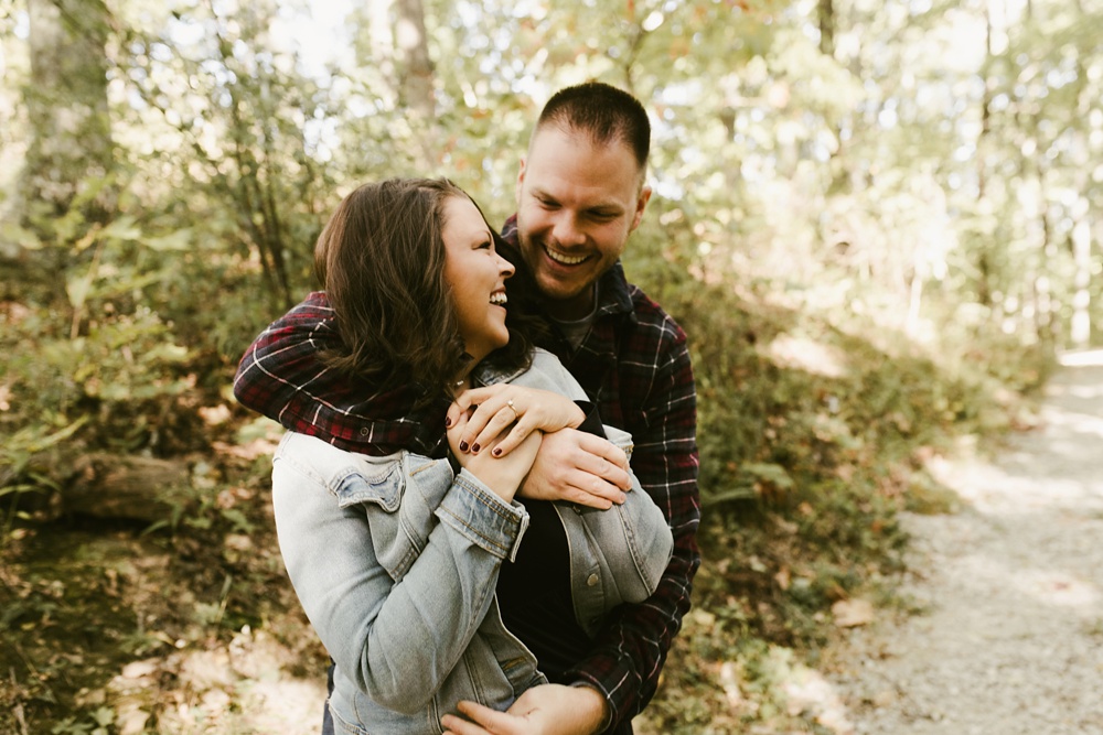 couple hugging in woods at brown county engagement session