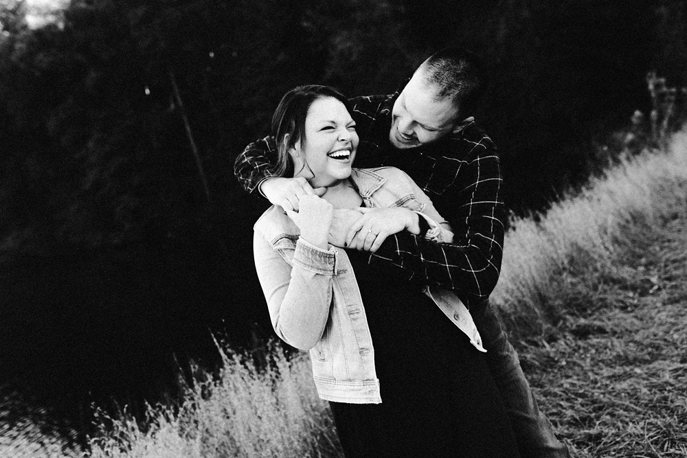 couple hugging and laughing at brown county engagement session