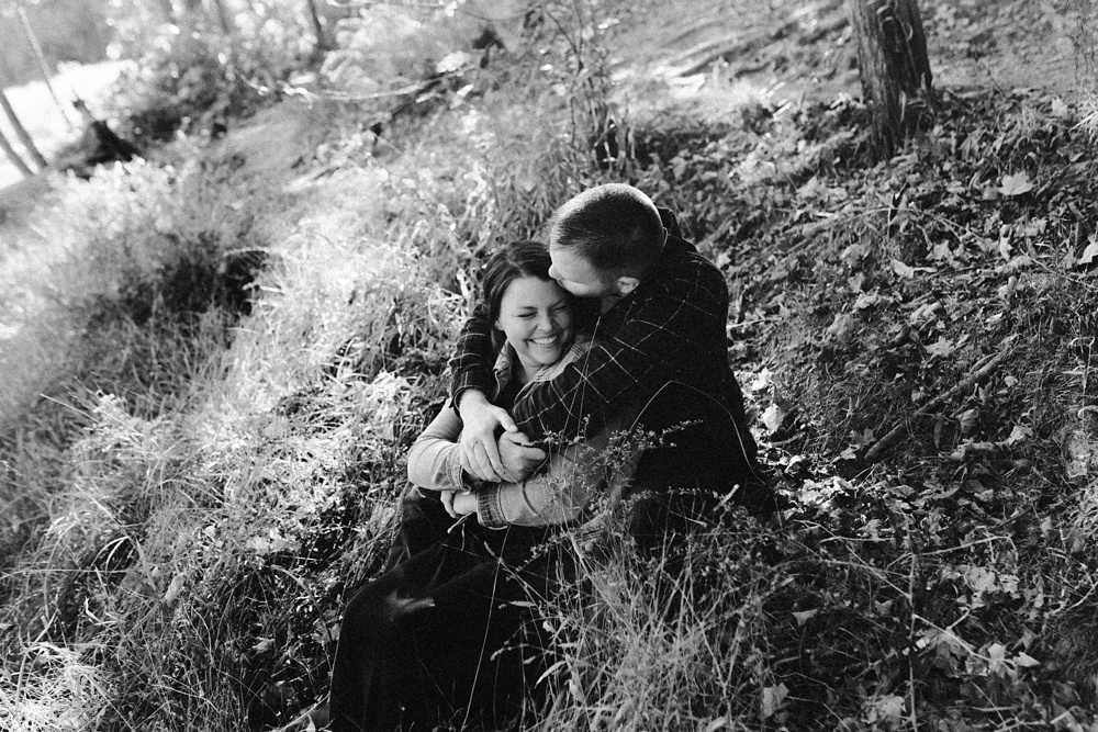 couple hugging in grass at brown county engagement session