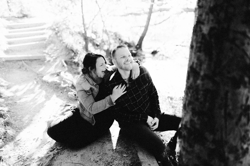 couple laughing in woods at brown county engagement session
