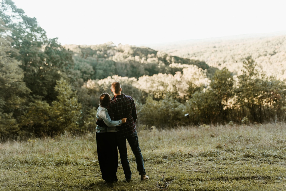 couple hugging overlooking brown county forest at brown county engagement session