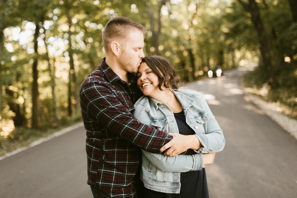 couple laughing and kissing at brown county engagement session