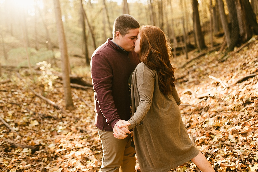 couple kissing at chain o'lakes fall engagement session
