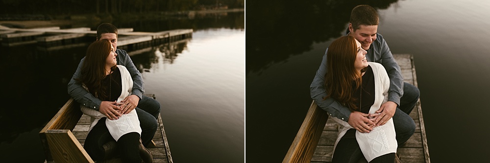 couple hugging on pier at chain o'lakes fall engagement session