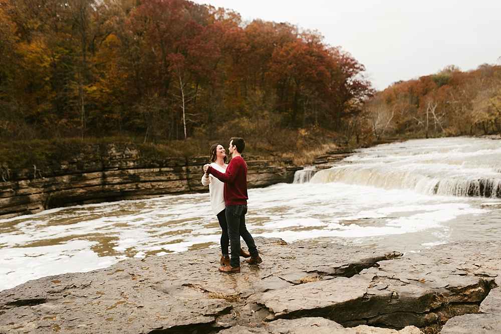 couple dancing near lake at cataract falls fall engagement session