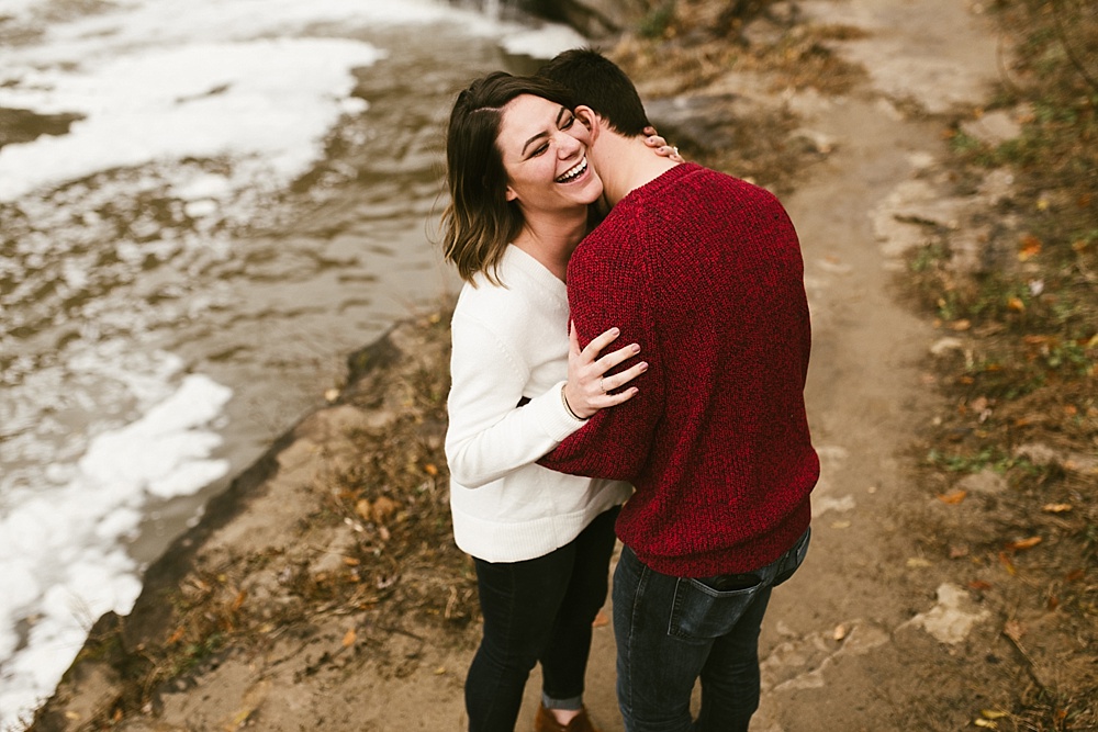 couple hugging and laughing at cataract falls fall engagement session