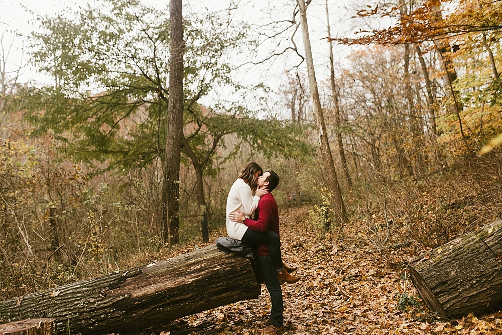 couple hugging in woods at cataract falls fall engagement session