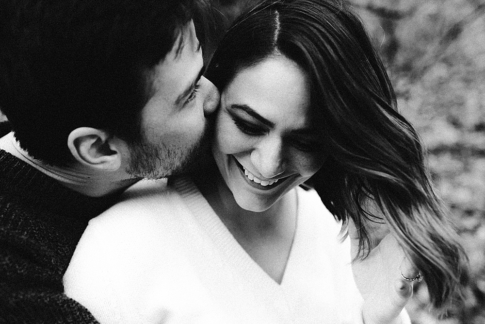 couple kissing at cataract falls fall engagement session