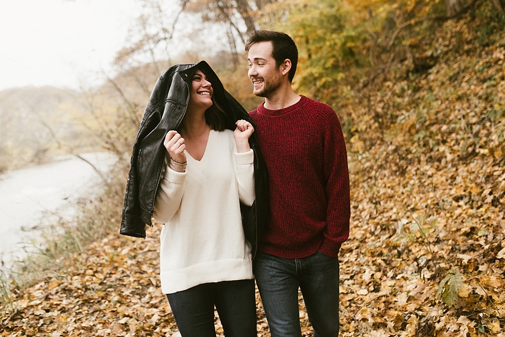 couple laughing in woods at cataract falls fall engagement session