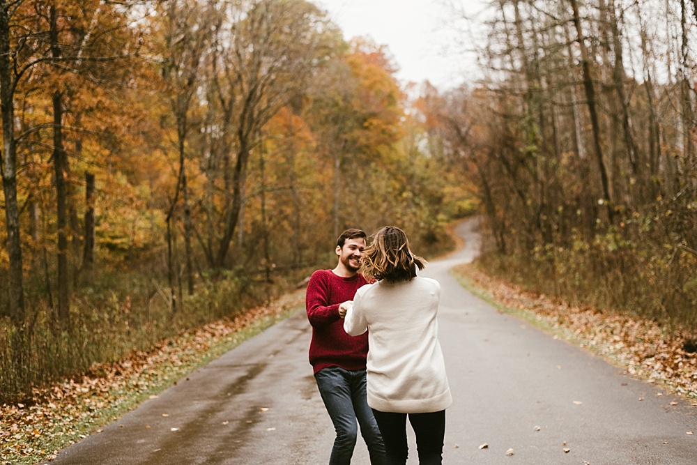 couple dancing in road at cataract falls fall engagement session