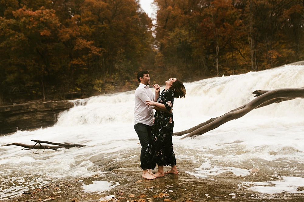 couple dancing in water at cataract falls fall engagement session