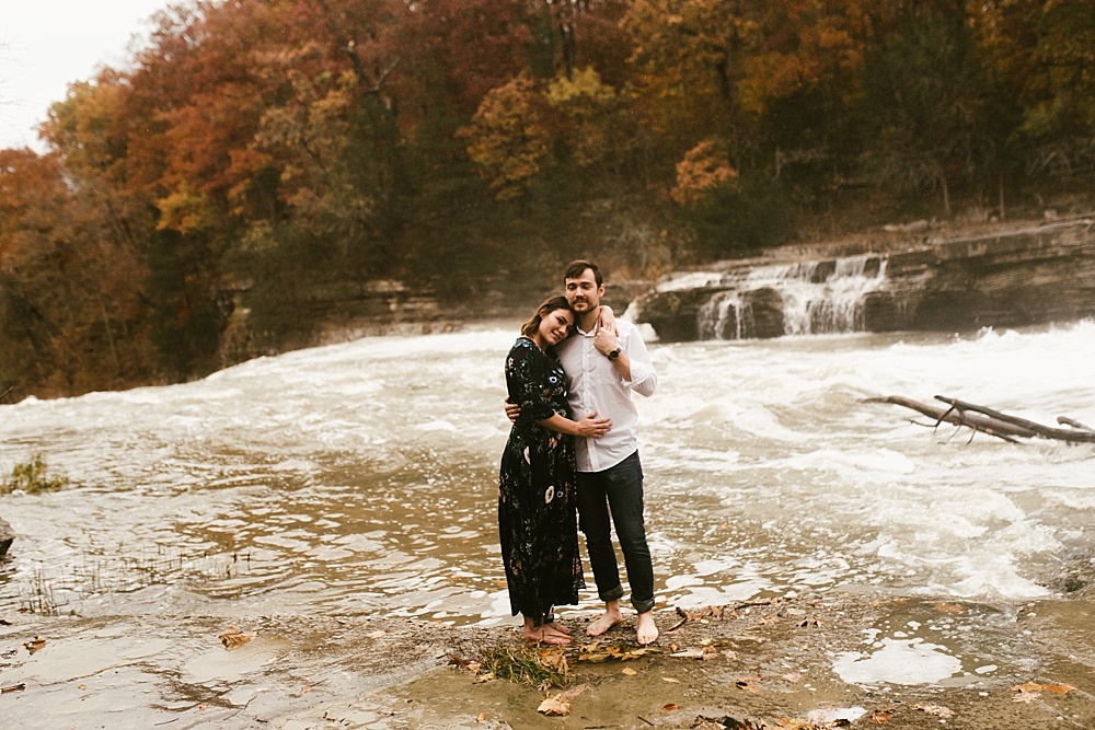 couple hugging in water at cataract falls fall engagement session