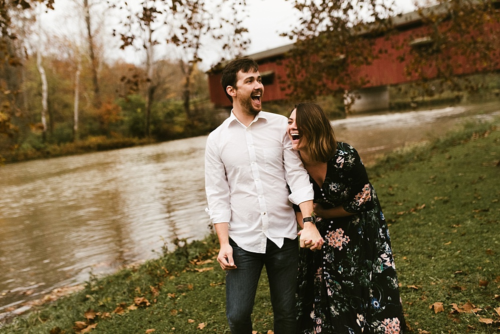 couple laughing at cataract falls fall engagement session