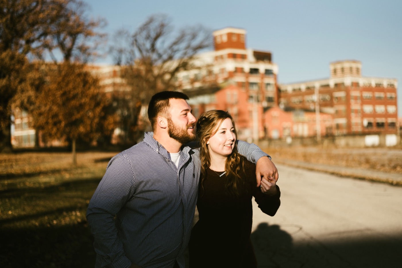 couple walking through GE campus at downtown fort wayne engagement session