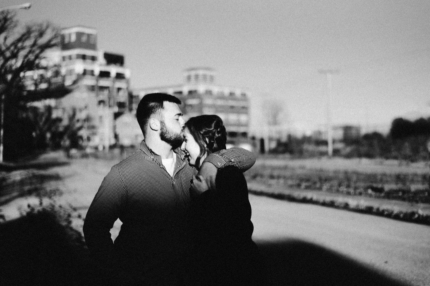 couple kissing on GE campus at downtown fort wayne engagement session
